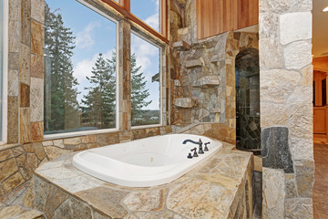 Luxurious Drop-In Bathtub paneled in stone tiles