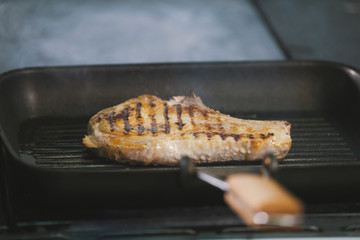 The meat on the grill cooked in restaurant