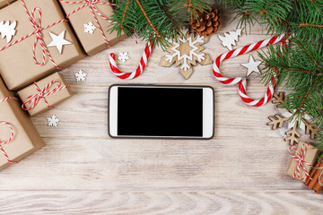 Smart phone mock up with rustic Christmas decorations for app presentation. View from above