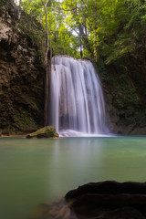 Fototapeta na wymiar The beauty of limestone waterfall is popular with tourists. And famous of Thailand. In Erawan Waterfall National Park Kanchanaburi