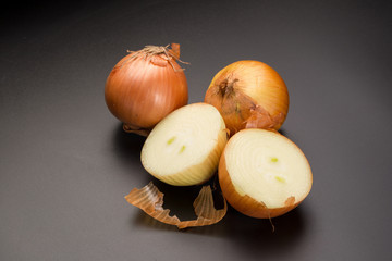 Fresh golden onions isolated on a black background
