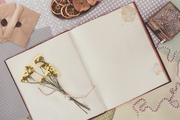 top view of opened book with flowers and copy space