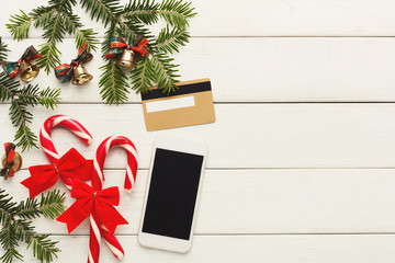 Smartphone, christmas decorations and credit card