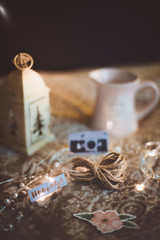 Moody rustic cinnamon colour style Christmas composition with small camera and the bokeh background