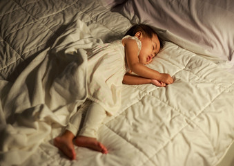 baby sleeping on bed at home