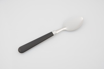 dessert spoon in chromed metal with a black handle
