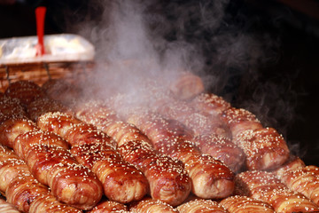 Steaming bread and bacon sprinkle with white sesame seeds. and steam up above the food on sunlight.