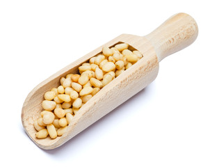 Scoop full of Roasted pine nuts isolated on white background. Clipping path