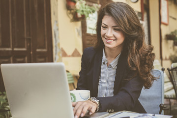 Fototapeta premium Young business woman working at cafe.