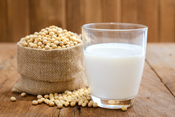 Soy milk and soy bean on wooden background