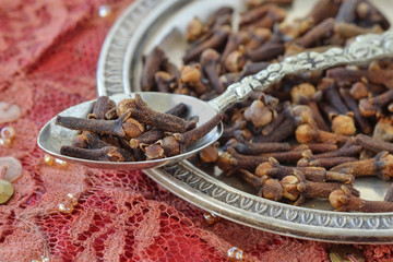 Cloves on spoon and metal plate