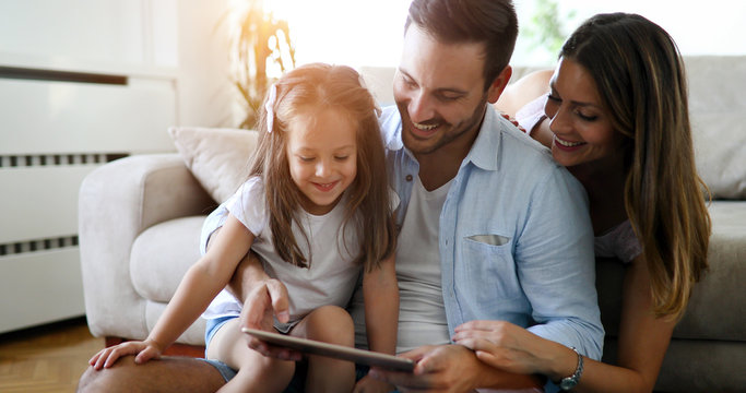 Family Holding A Tablet And Looking At It