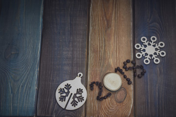 2018 inscription of coffee beans and a wooden circle, a wooden toy snowflake and ball on a colored wooden background. Copy space