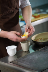 The chef separates the whites then yolks