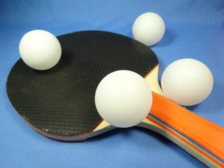 table tennis bat and a ball