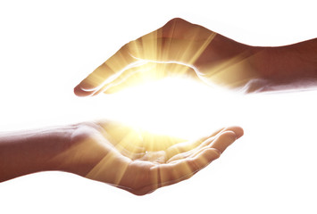 Woman hands protecting and containing bright, glowing, radiant, shining light. Emitting rays or...