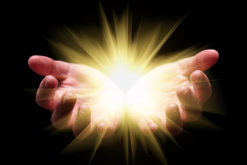 Woman hands cupped holding, showing, or emanating bright, glowing, radiant, shining light. Emitting...
