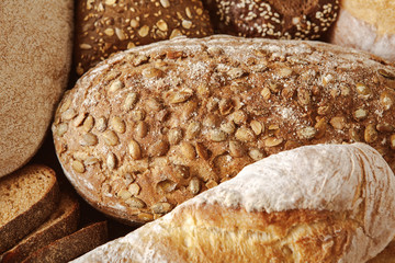 Bread background, closeup of white, black and rye loaves