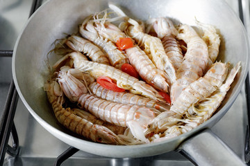Sea cicadas, cooking in a pan.