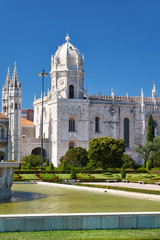 Fototapeta na wymiar The view of Church of Santa Maria through the garden of Empire square. Lisbon, Portugal