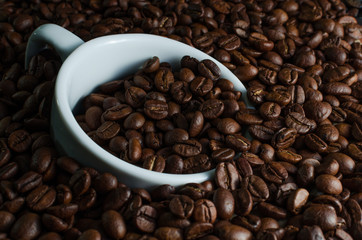 White Cup drowned in coffee beans