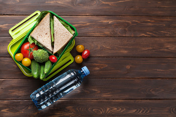 Lunch box with vegetables and sandwich