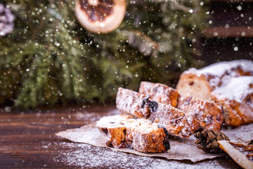   Christmas or New Year pastries Holidays Concept Dresdnen Stollen is a Traditional German Cake Wooden Background Gift Fruit Cake Holiday , European festive dessert  Decoration Snowfall