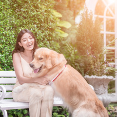 Portrait of woman with dog golden retriever in park with sunset out door