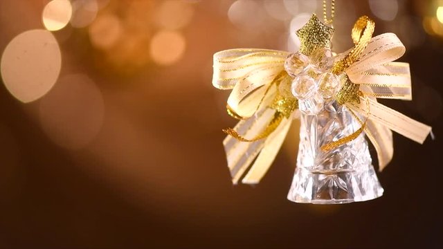 Christmas and New Year golden bell decoration. Abstract blinking holiday background. Slow motion 4K UHD video footage. 3840X2160