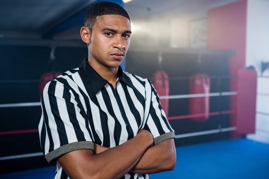 Portrait of confident male referee with arms crossed - Powered by Adobe