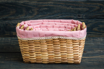 Decorative Rattan Baskets with Pink Lining Fabric on  Wooden Background