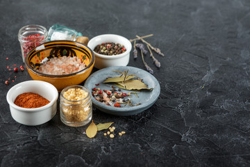 Black food background with spices.