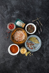 Black food background with spices.