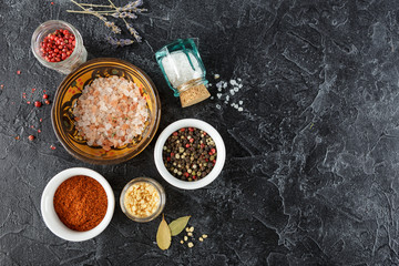 Black food background with spices.