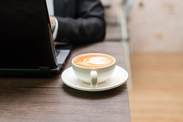 Asian young business man working with laptop in coffee shop cafe