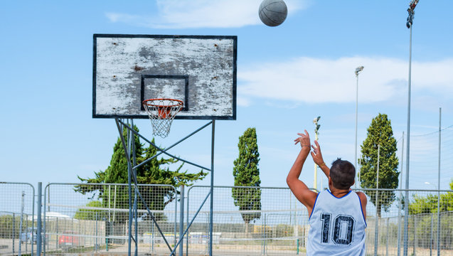 Basketball player shooting in a playground