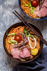 Noodle soup Asian with meat, vegetables and herbs, squid, lemon