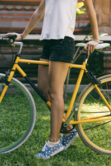 Naklejka premium Pretty woman riding old bicycle outdoors.