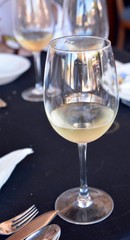 Celebration with a glass of white wine.