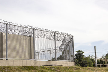 The barbed wire barrier to prevent the inmate of the prisoner.