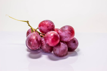 Red grapes cooked on white back ground.