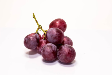 Red grapes cooked on white back ground.