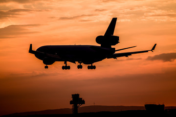 Airplane landing at sunset