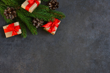 Christmas card with decorations from a Christmas tree with gifts on a black background.
