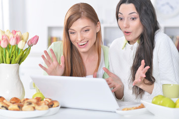 young women looking at laptop