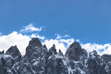 Fototapeta na wymiar front view of italian dolomites, snowy mountains with copy space on the blue sky