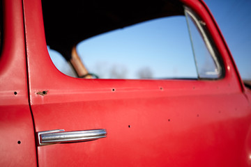 Side window of an old vintage red car