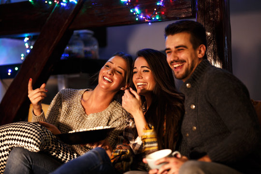 Group Best Friends Sitting At Home On Pleasant  Evening And Watching A Comedy Movie .Watching Late Night Show.