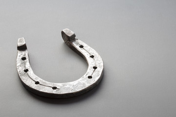 Retro horseshoe on grey background with place for text