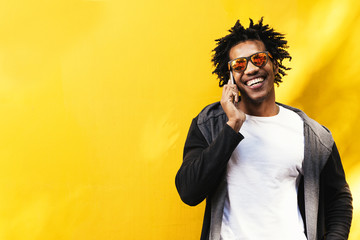 Portrait of handsome afro man using his mobile.